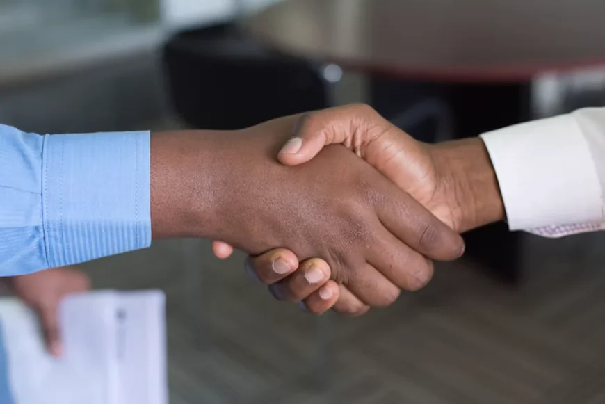 Aperto de mãos representando cooperação e liderança responsável